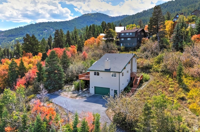 drone / aerial view featuring a forest view and a mountain view