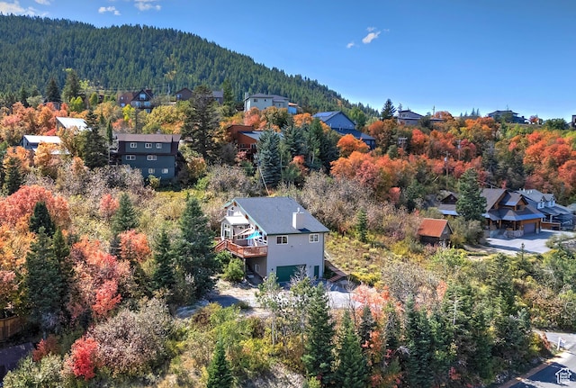 birds eye view of property featuring a residential view and a wooded view