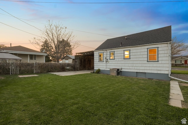 rear view of property featuring a gazebo, fence, a yard, a patio, and roof with shingles