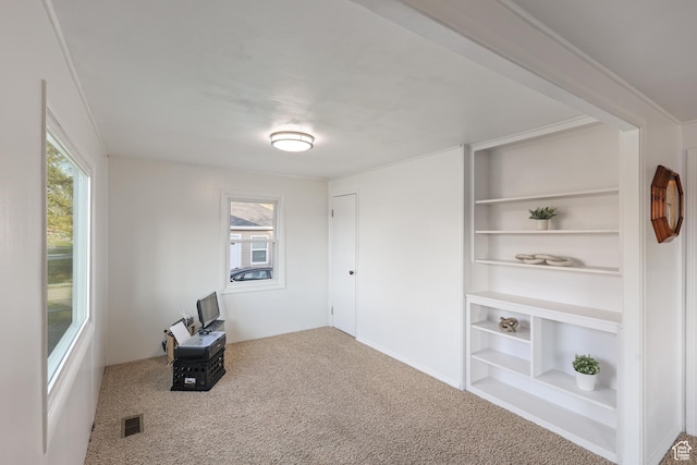 unfurnished room featuring carpet floors and visible vents