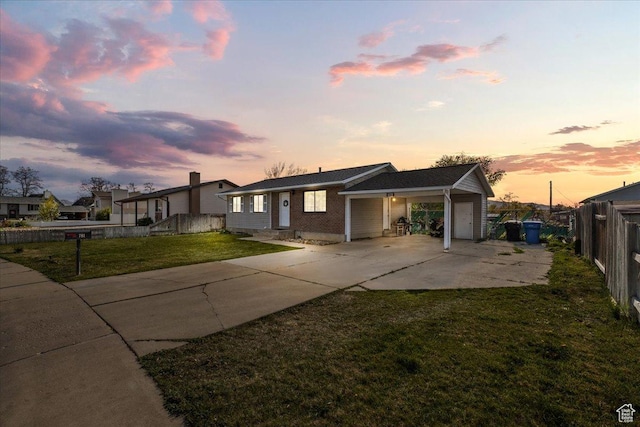 781 N 950 W, Orem, UT 84057 - view of front of house featuring a lawn, driveway, an attached garage, fence, and an attached carport