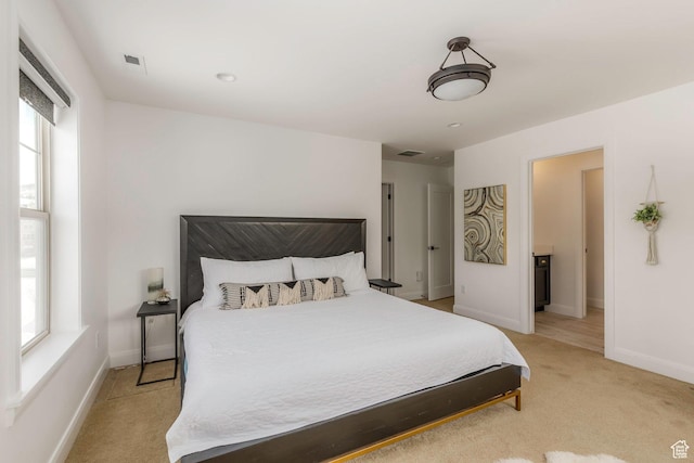 1052 W Cattail Ct Unit E1, Kamas, UT 84036 - bedroom with baseboards, visible vents, and light colored carpet