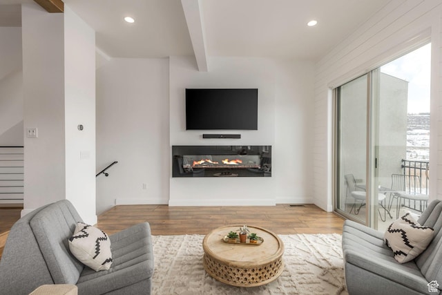 1052 W Cattail Ct Unit E1, Kamas, UT 84036 - living room featuring wood finished floors, a multi sided fireplace, beamed ceiling, visible vents, and recessed lighting