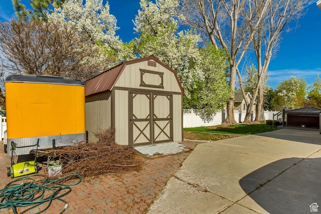 view of shed featuring fence