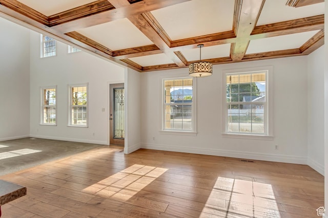 unfurnished room featuring beamed ceiling, light wood-type flooring, baseboards, and coffered ceiling