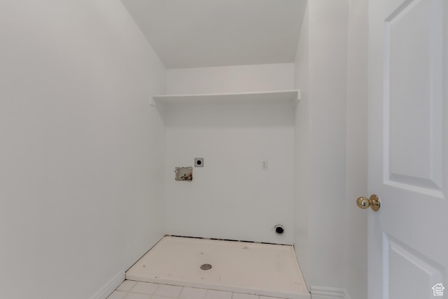clothes washing area with laundry area, hookup for an electric dryer, light tile patterned flooring, baseboards, and washer hookup