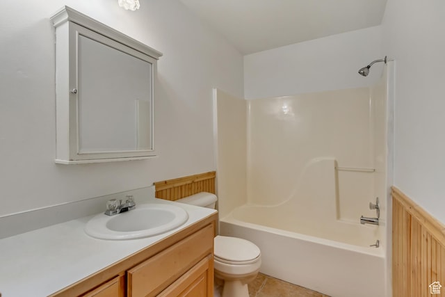 bathroom with tile patterned flooring, toilet, shower / bathtub combination, and vanity