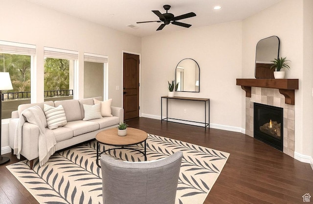 living room with a tiled fireplace, baseboards, recessed lighting, wood finished floors, and ceiling fan