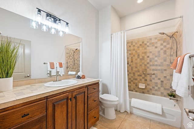 bathroom featuring shower / bath combo with shower curtain, toilet, vanity, and tile patterned floors