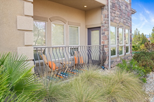 exterior space with stone siding and stucco siding