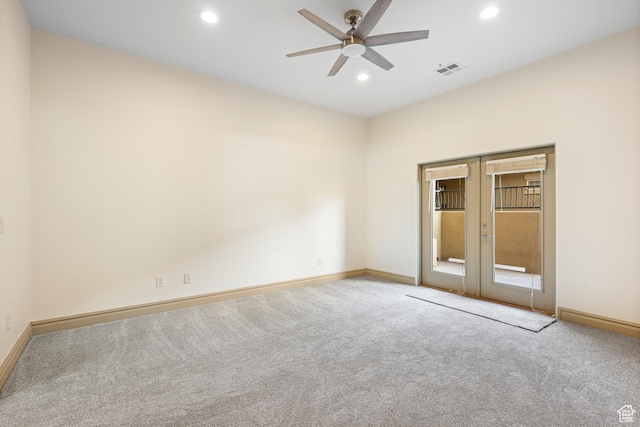 carpeted spare room with baseboards, a ceiling fan, french doors, and visible vents