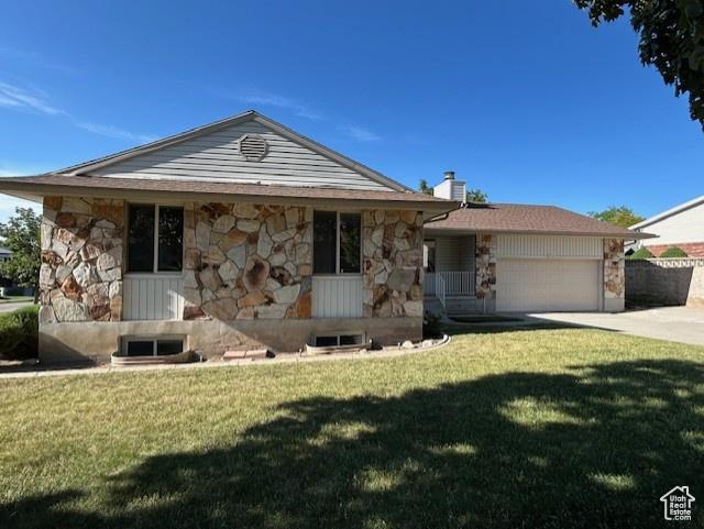 704 W Daisy Ln S, Murray, UT 84123 - view of front of home featuring stone siding, an attached garage, a front yard, driveway, and a chimney