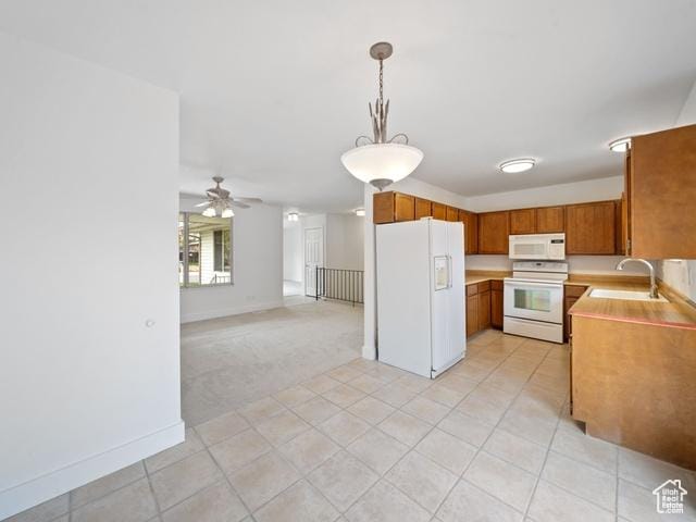 704 W Daisy Ln S, Murray, UT 84123 - kitchen featuring brown cabinets, light countertops, a sink, light tile patterned flooring, and white appliances