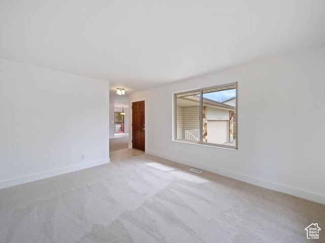 704 W Daisy Ln S, Murray, UT 84123 - spare room featuring light carpet and baseboards