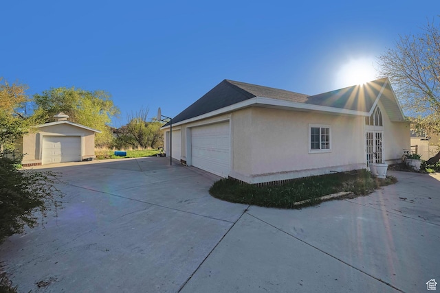view of property exterior featuring stucco siding and a garage