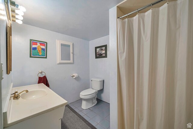 bathroom featuring toilet, vanity, and tile patterned floors