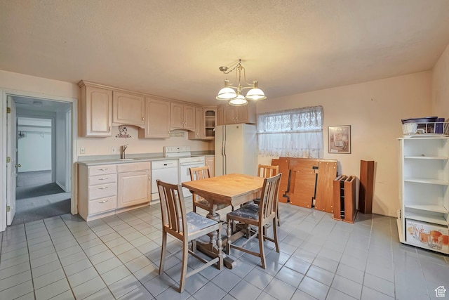 dining room with a chandelier and light tile patterned floors