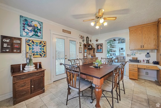 dining area with ornamental molding, baseboards, a ceiling fan, and french doors