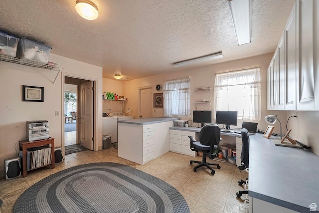 office featuring a textured ceiling and washer and clothes dryer