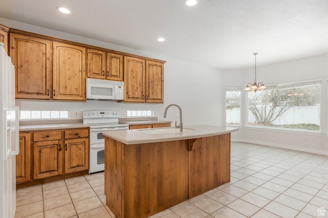 kitchen featuring light countertops, white appliances, a sink, and light tile patterned flooring
