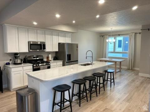 413 S 980 W, American Fork, UT 84003 - kitchen featuring recessed lighting, a large island, a sink, appliances with stainless steel finishes, and white cabinetry