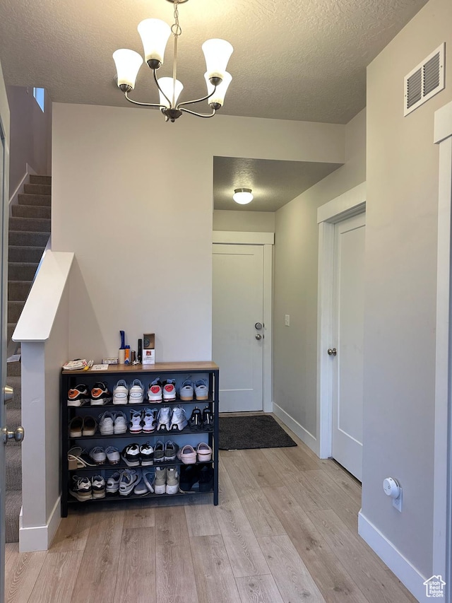 413 S 980 W, American Fork, UT 84003 - entrance foyer with baseboards, visible vents, a chandelier, wood finished floors, and stairs