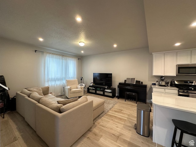 413 S 980 W, American Fork, UT 84003 - living room featuring light wood-type flooring, recessed lighting, and a textured ceiling