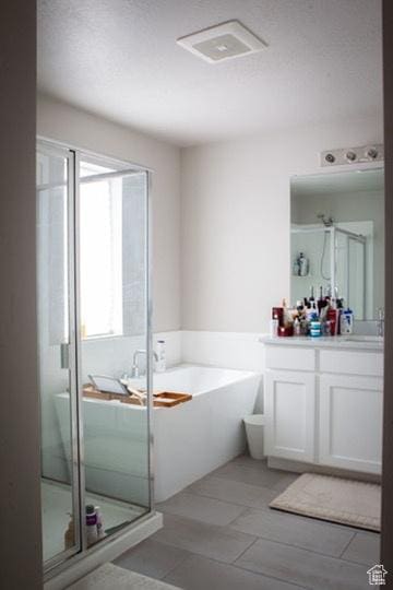 413 S 980 W, American Fork, UT 84003 - bathroom with a textured ceiling, a stall shower, a bath, vanity, and visible vents