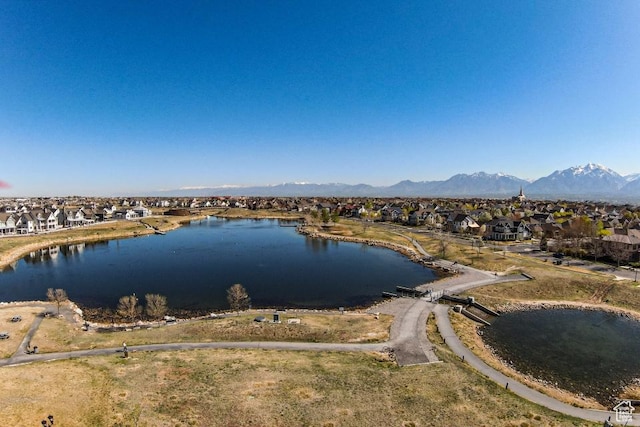 property view of water with a mountain view and a residential view