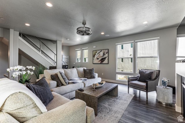living room with baseboards, a textured ceiling, dark wood-style floors, and recessed lighting