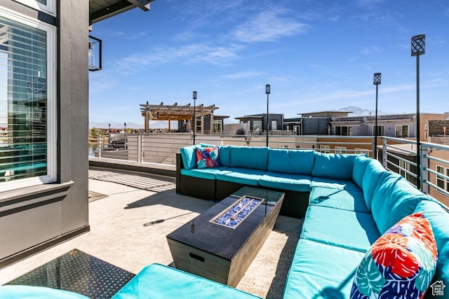 view of patio / terrace with an outdoor living space with a fire pit