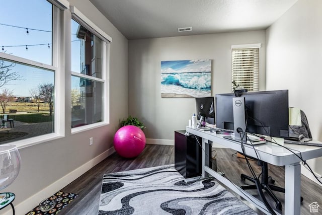 office with visible vents, baseboards, and wood finished floors