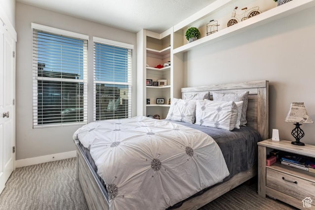 carpeted bedroom featuring baseboards