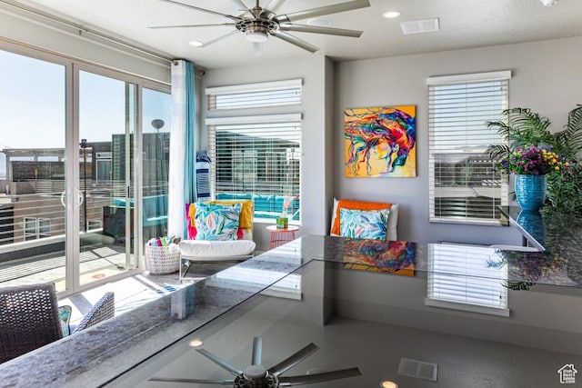 interior space with a ceiling fan, visible vents, and recessed lighting