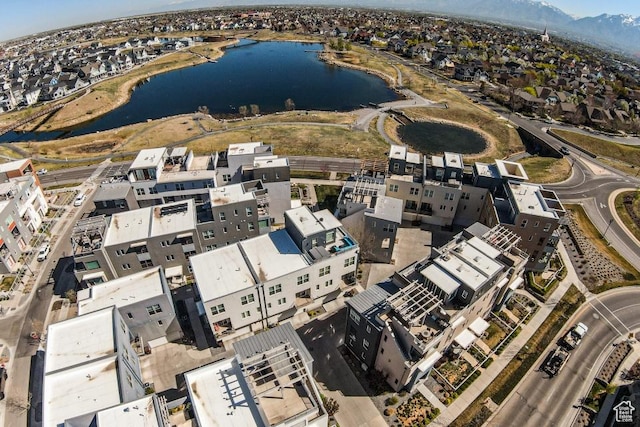 drone / aerial view with a water and mountain view and a residential view