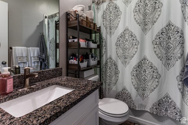 bathroom featuring toilet and vanity