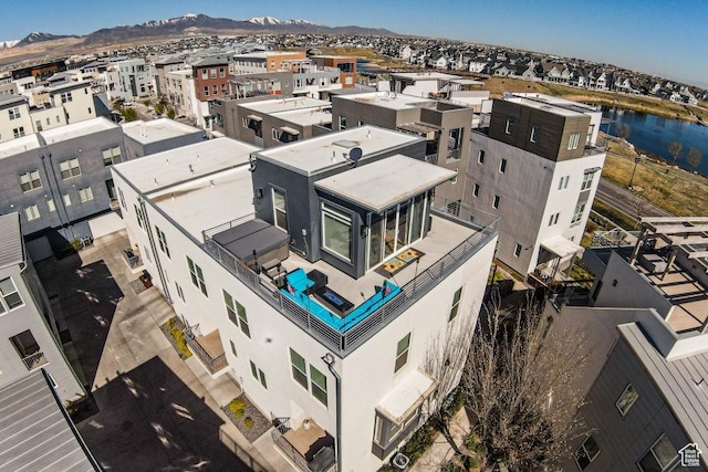 aerial view with a water and mountain view and a residential view
