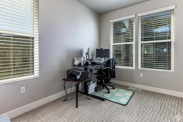 office space with visible vents, baseboards, and carpet flooring