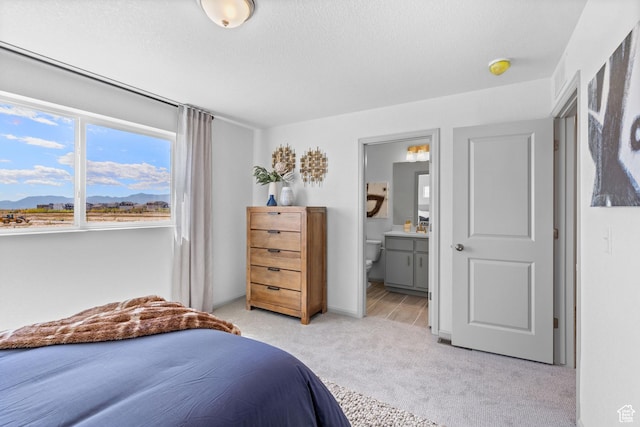 947 N Riverside Dr Unit 977, Saratoga Springs, UT 84045 - bedroom with ensuite bath, light carpet, and a mountain view