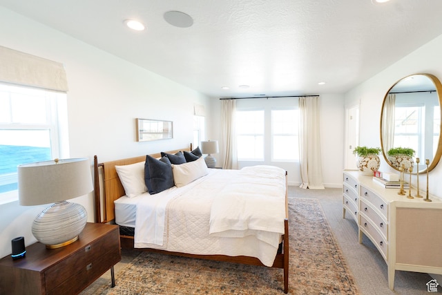 carpeted bedroom with recessed lighting