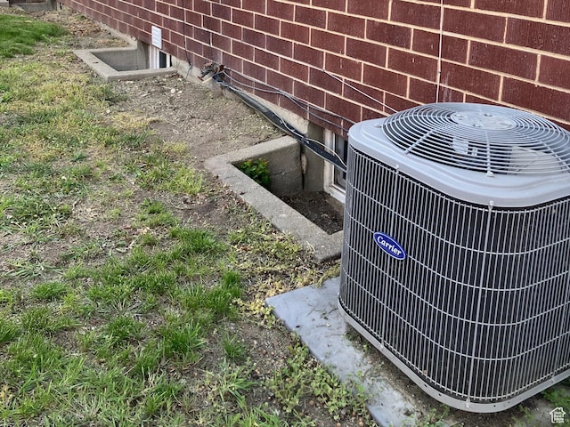 details featuring brick siding and central air condition unit