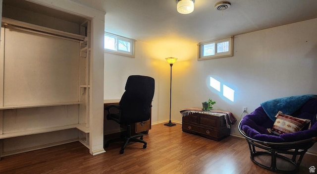 home office featuring baseboards, wood finished floors, and visible vents