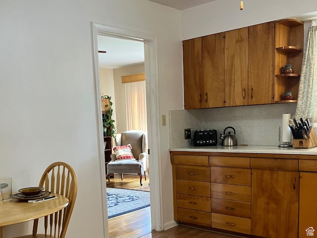 kitchen featuring brown cabinets and dark wood-type flooring