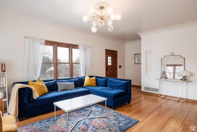 79 E Hillside Ave, Salt Lake City, UT 84103 - living room with visible vents, a wealth of natural light, wood finished floors, and an inviting chandelier