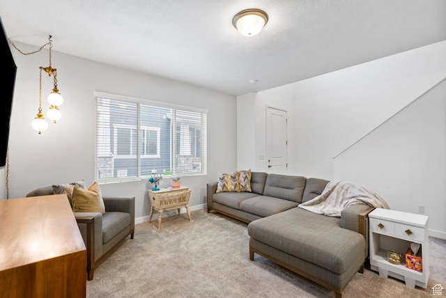 living room featuring baseboards and light carpet