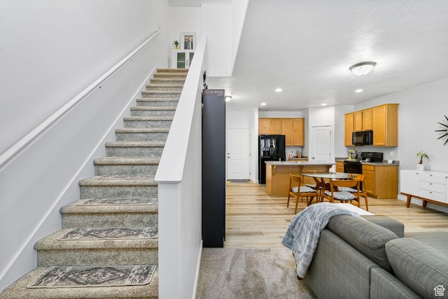 staircase featuring recessed lighting and wood finished floors