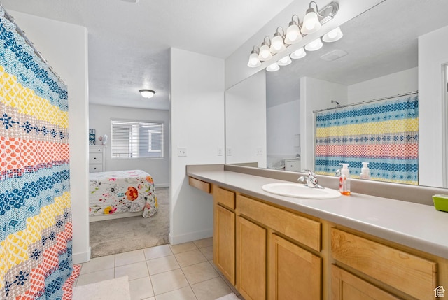 full bath with tile patterned flooring, vanity, curtained shower, baseboards, and connected bathroom