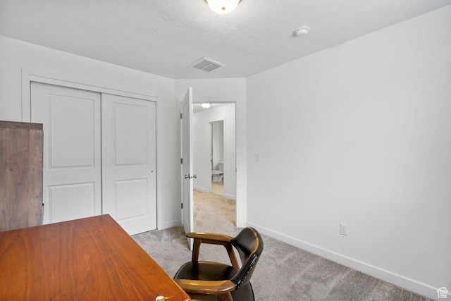 carpeted office space with visible vents and baseboards