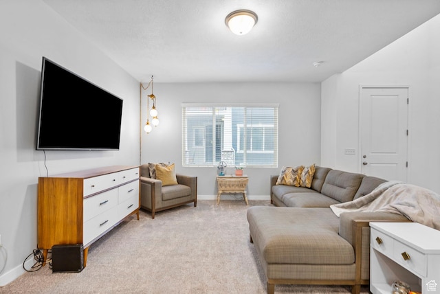 living area with light colored carpet and baseboards
