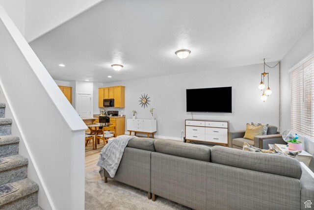 living room featuring recessed lighting and stairway